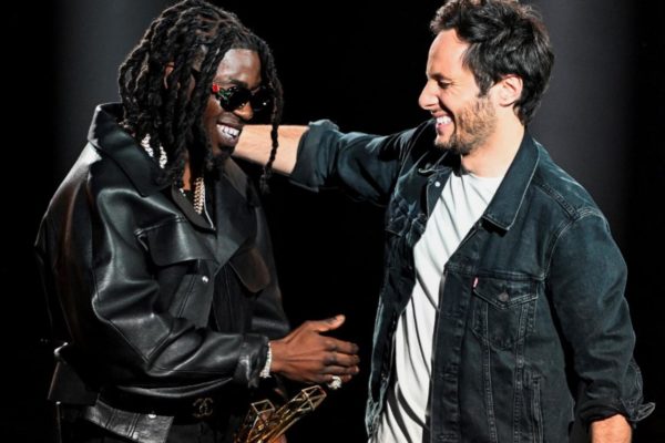 French rapper Gazo (L) and French singer, songwriter Vianney celebrate after both winning the Best Male Artist award during the 39th Victoires de la Musique, the annual French music awards ceremony, at the Seine Musicale concert hall in Boulogne-Billancourt, on the outskirts of Paris, on February 9, 2024. (Photo by Bertrand GUAY / AFP)
